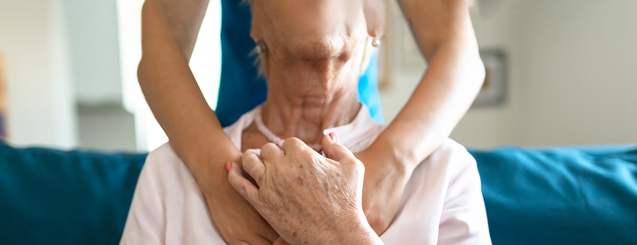 caregiver hugging senior patient