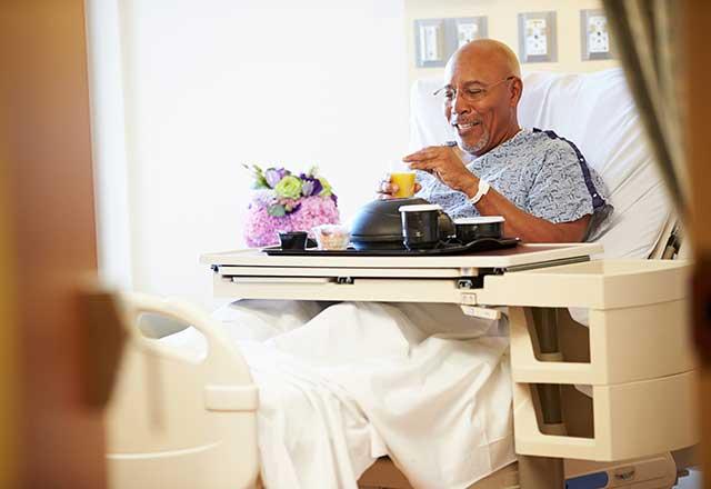 Patient eating in hospital bed